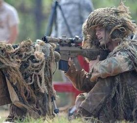 Army Spc. Lawrence England, a sniper with the 25th Infantry Division, Schofield Barracks, Hawaii, looks over his rifle downrange at his target during the 10th Annual International Sniper Competition at Fort Benning, Ga. 