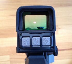 Left button: Brightness control. Center button: On/off. Right button: Reticle selection.