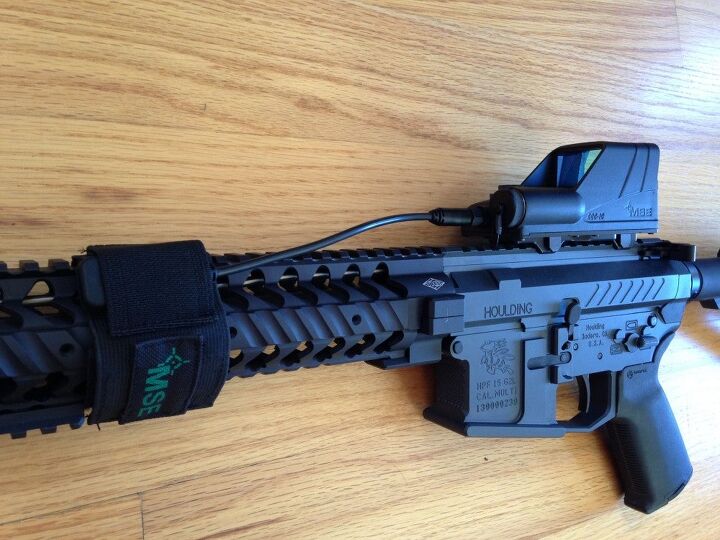 The PTT button inside of a provided nylon cover, secured by velcro on the forearm.