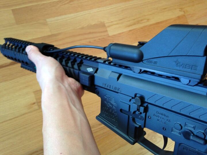 View of the support hand with the thumb on the PTT button.