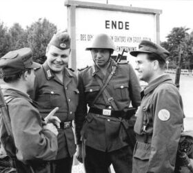 Original text: '14 August 1961, Erection of the Berlin Wall. GDR borderguards and members of a Combat Group of the Working Class at the border of the Berlin sector.' The rifleman in the distinctive East German helmet is carrying an SKS carbine, while the two Combat Group members are carrying antiquated Kar.98k rifles. Image source: en.wikipedia.org