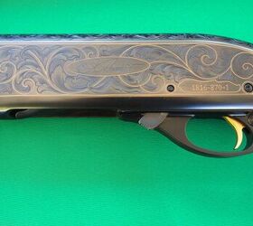 The left side of a high grade 870 with engraving covering the receiver and gold inlay throughout.