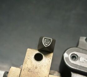 Barrett crest proof marking stamp. This is at the magnetic particle inspector station. 