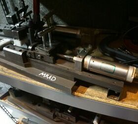 This is a pneumonic air compressor device fixture that is used to blow air at an MRADs trigger, thus remotely firing the rifle with proof rounds, while the tester can stay back behind safety. 