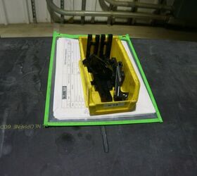 240 LW bolts, having just been taken out of the parkerizing tank. Underneath them is the flow sheet that tells employees where they need to go next, who signed off on their process, who signed off on quality control, etc...