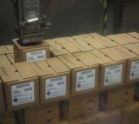 Robotic arm loading cases onto the pallet.