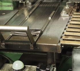 Trays are placed in front of these railed slides where the machine seats the bullets all in one stroke.