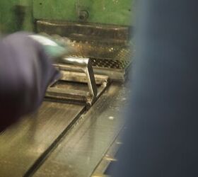Employee pushing the trays into the machine where the bullets are seated in the cases.