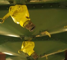 There are about a dozen of these holding containers lined up in a row with different sizes of shot.