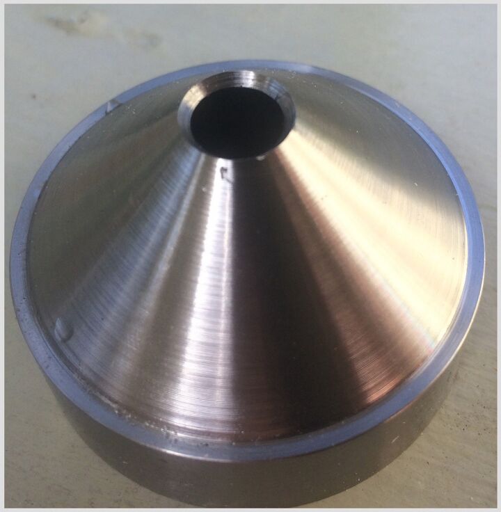 A freshly drilled titanium baffle I made for a 5.56mm Form 1 suppressor.