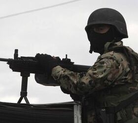 A Mexican marine stands guard on a street on the outskirts of Puebla September 12, 2010. Mexican marines captured Sergio Villarreal, dubbed 'El Grande', a top lieutenant of a leading drug cartel, on Sunday as authorities intensified their campaign against drug kingpins, local media reported. REUTERS/Stringer (MEXICO - Tags: CRIME LAW POLITICS)