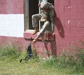 Original caption: 'Spc. Alfredo Hernandez departs through a window during an assessment of military operations in urban terrain at Fort Benning, Ga. Soldiers ran the course on the mock city twice, once with each [LSAT] weapon.' Image credit: Eric Kowal, RDECOM. Public domain.