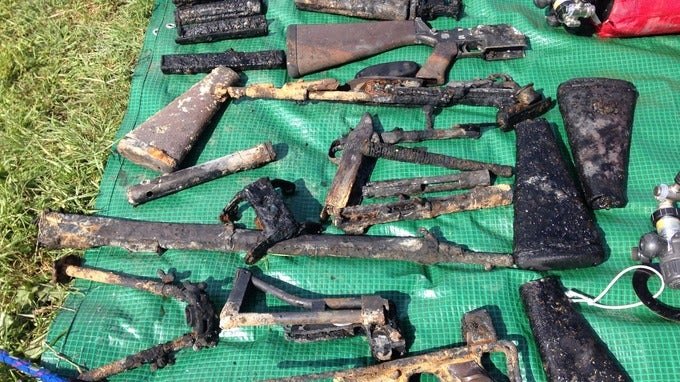Some of the guns pulled from the river by police divers, various bolts, magazines and barrels as well as a number of AR-15 stocks and a stock from a PARA FAL and the lower half of what looks like a French MAT-49 SMG. (ITV West Country)