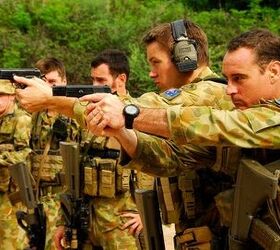 Private Greg Harris and Private Peter Hallin fire their 9mm Browning pistols, during a range practice in Dili, East Timor, 2009. (Photo: Royal Australian Army)
