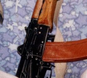 Note how this sling is beige in color, especially when comparing it to the white robes of UBL to the left. It is frayed midway and has those 3 grommets stamped into the thin strip of metal clamping the end of the webbing together.