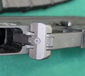 The magazine release button extension is attached via a screw