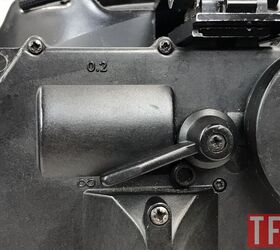 Lower the lever for infinite focus, raise it for close focus.