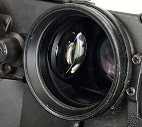 Moving the focus lever pulls and pushes this objective lens left and right.