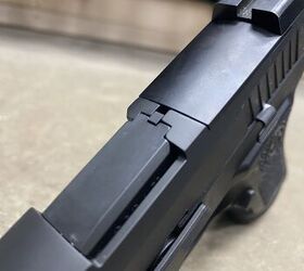 The standard XCompact with its loaded chamber indicator and optics plate with iron sights attached.