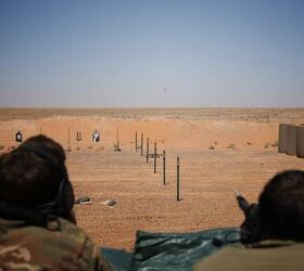 A Soldier uses a Smart Shooter sighting device to fire at a drone-carried target box flying more than 100 meters away during a familiarization range near At-Tanf Garrison, Syria, May 30, 2020. (DoD/Staff Sgt. William Howard)