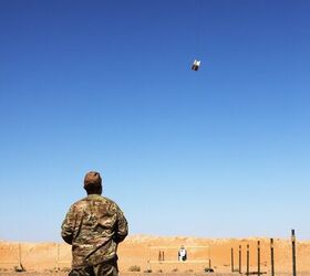 A Soldier controls a drone that's carrying a box to be used as a target during a Smart Shooter sighting device familiarization range near At-Tanf Garrison, Syria, May 30, 2020. (DoD/Staff Sgt. William Howard)