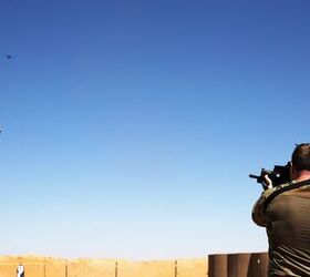 A Soldier uses a Smart Shooter sighting device to fire at a box carried by a drone during a familiarization range near At-Tanf Garrison, Syria, May 30, 2020. (DoD/Staff Sgt. William Howard)