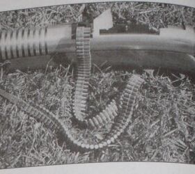 The first prototype with a loaded section of the belt (notice the lack of a forward grip underneath the barrel vent ribs)