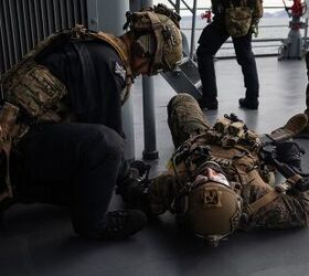 A medic with 42 Commando, Royal Marines, simulates administering aid to Sgt. Aaron Bernal, Reconnaissance Marine, Charlie Company, 2nd Reconnaissance Battalion assigned to 22nd Marine Expeditionary Unit, during a visit, board, search, and seizure training mission in the Atlantic Ocean in support of exercise Northern Viking 2022 , April 12, 2022. Northern Viking 22 strengthens interoperability and force readiness between the U.S., Iceland and Allied nations, enabling multi-domain command and control of joint and coalition forces in the defense of Iceland and Sea Lines of Communication in the Greenland, Iceland, United Kingdom (GIUK) gap. (U.S. Marine Corps photo by Cpl. Henry Rodriguez)