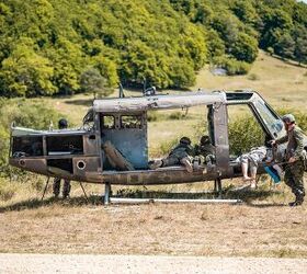 Estonian soldiers identify targets from a downed UH-60 Blackhawk during the European Best Sniper Team Competition at the Hohenfels Training Area, Germany, Aug. 6, 2022.  The annual European Best Sniper Team Competition is a U.S. Army Europe and Africa competition that tests marksmanship skills, physical prowess, and mental agility while developing relationships and sharing skills between sniper teams across Europe. (U.S. Army photo by Staff Sgt. Dana Clarke)