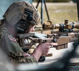 A Latvian soldier takes a shot from a downed helicopter as part of the Mogadishu lane of the European Best Sniper Team Competition at the Hohenfels Training Area, Germany, Aug. 6, 2022.  The annual European Best Sniper Team Competition is a U.S. Army Europe and Africa competition that tests marksmanship skills, physical prowess, and mental agility while developing relationships and sharing skills between sniper teams across Europe. (U.S. Army photo by Staff Sgt. Dana Clarke)