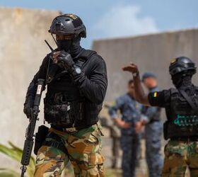 A member of the Ghana Armed Forces calls into a team leader to be extracted from the objective after clearing a house. (U.S. Army photo by Staff Sgt. Charles Brock)