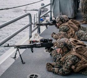 U.S. Marines assigned to Bravo Company, Battalion Landing Team 1/5, 15th Marine Expeditionary Unit, provide security manning M240B machine guns aboard the amphibious assault ship USS Boxer (LHD 4) while the ship fires a 25 mm gun during an integrated live-fire exercise in the Pacific Ocean, Dec. 12, 2023.  The 15th MEU is currently embarked aboard the Boxer Amphibious Ready Group conducting integrated training and routine operations in U.S. 3rd Fleet. (U.S. Marine Corps photo by Gunnery Sgt. Donald Holbert)