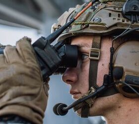 U.S. Marine Corps Sgt. Noah Junge, a scout sniper team leader assigned to Weapons Company, Battalion Landing Team 1/5, 15th Marine Expeditionary Unit, looks through binoculars to spot a target (U.S. Marine Corps photo by Cpl. Joseph Helms)