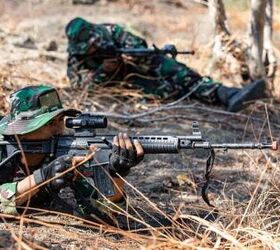 Two Indonesian Soldiers (TNI) pulls security with their Pindad SS1 assault rifles.