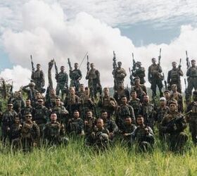U.S. Marines with 1st Battalion, 7th Marine Regiment, 1st Marine Division, and service members of the Armed Force of the Philippines pose for a photo.