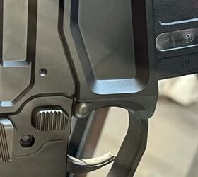 An ambidextrous bolt catch is on the right side of the gun