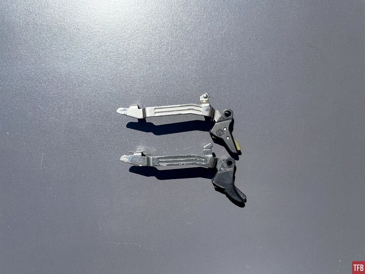 Shown is the right side profile of the Timney trigger shoe and bar, and Glock shoe and bar. Timney is shown at the top, Glock at the bottom.