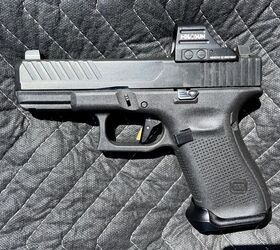 The Glock Timney Alpha trigger installed in a Gen 5 Glock 19. The trigger safety blade color is green.