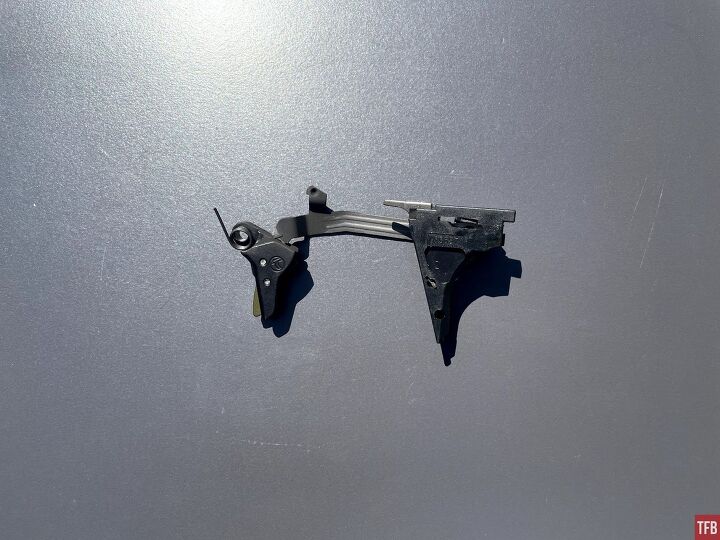 The left side profile of the Glock Timney Alpha Competition trigger, as it came out of the gun. It is still covered in carbon.