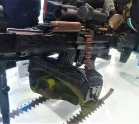 vietnam defence expo 2024 negev machinegun chambered for 7 62x39, First photos of the Negev in 7 62x39 note that the belt box is attached to the mag well for AK magazines by a part similar to the top of AK magazines Photo by V ng H i