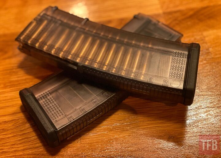 tfb review magpul tmag 30 magazines translucent olive drab hue, The TMAG 30 AR M4 GEN M3 is a translucent 30 round magazine designed for STANAG compatible firearms chambered in 5 56x45 NATO 223 Remington The front and rear straps are ribbed to provide a secure grip during magazine changes while the smooth sides are there to enhance visibility for quick round assessment