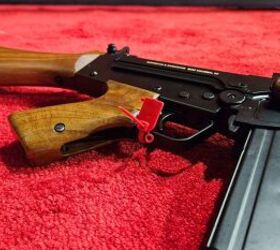 The trigger guard stows into the cut-out area in the pistol grip.
